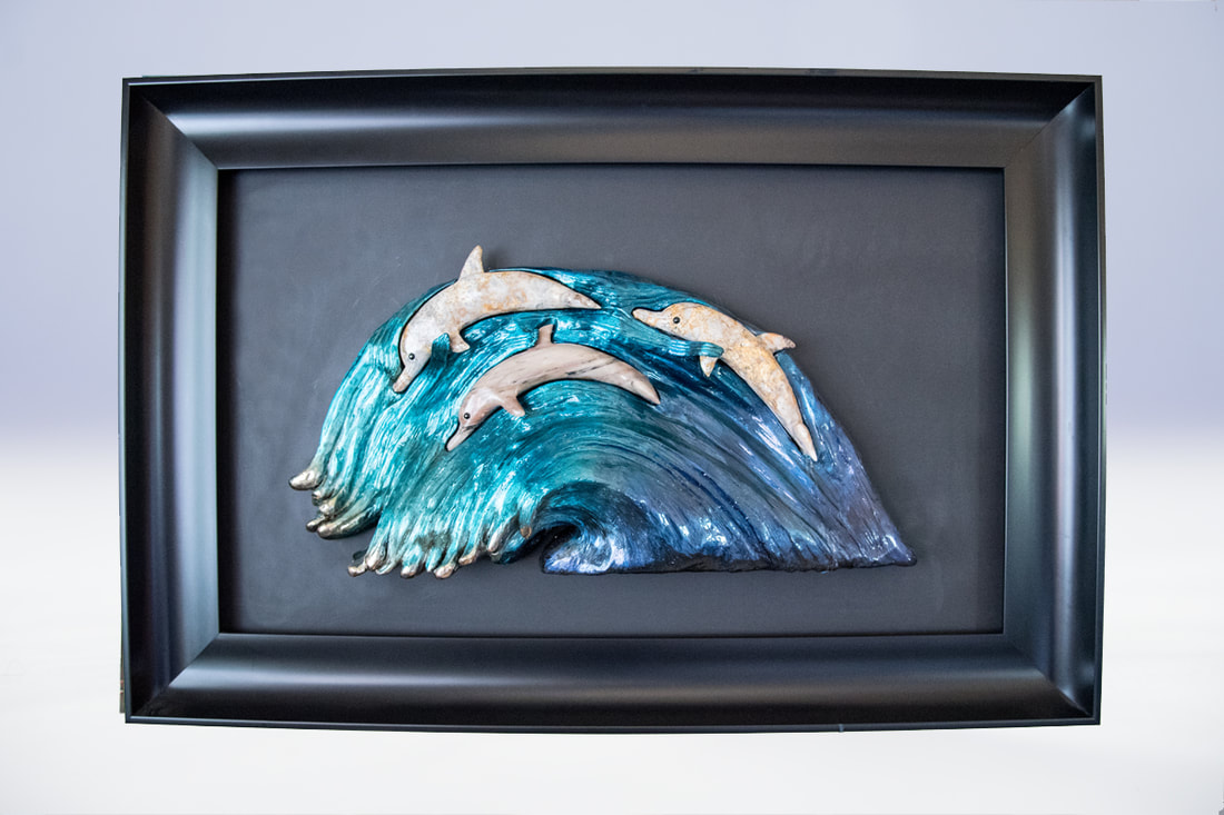 Bronze and stone dolphin sculpture