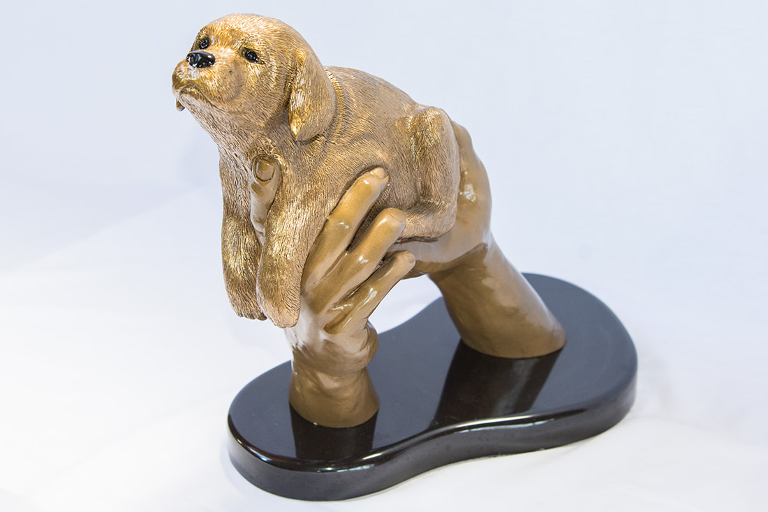 Bronze sculpture of a puppy